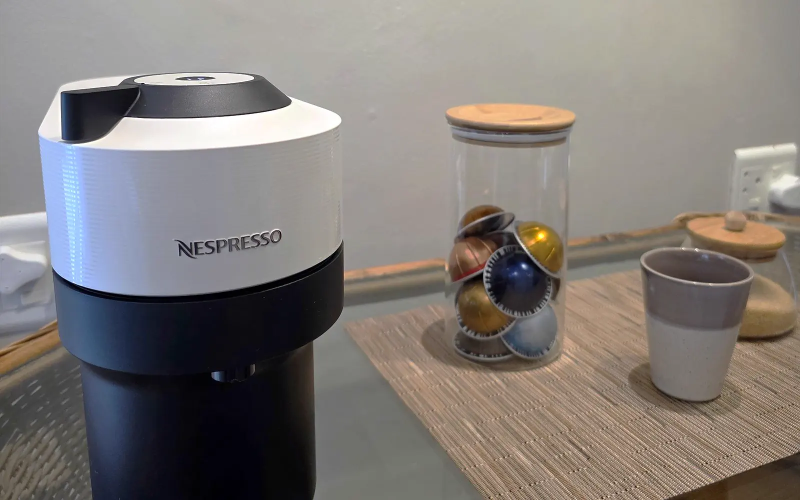 Nespresso machine with capsules and a cup in the coffee corner of The Library