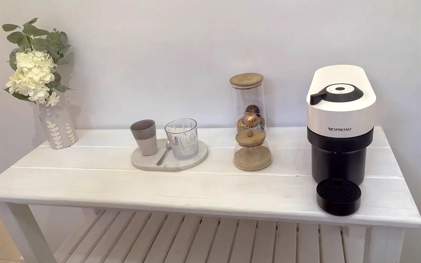 Coffee corner in The Lodge with Nespresso machine, cups and fresh flowers