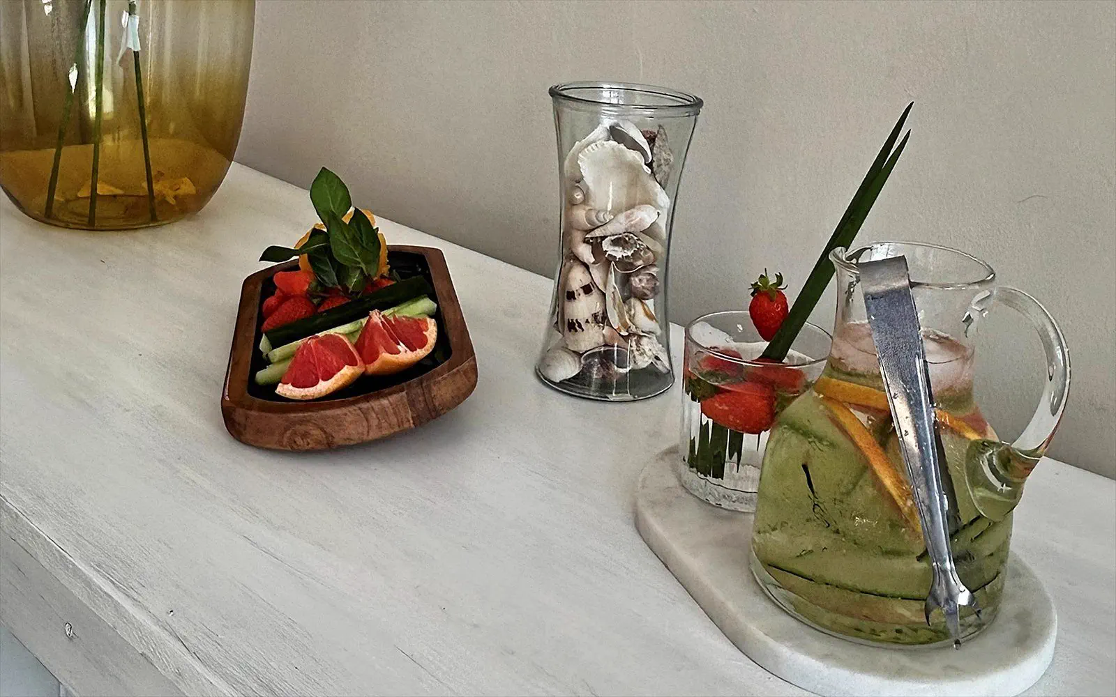 Fresh fruit and a carafe of infused water on the console table