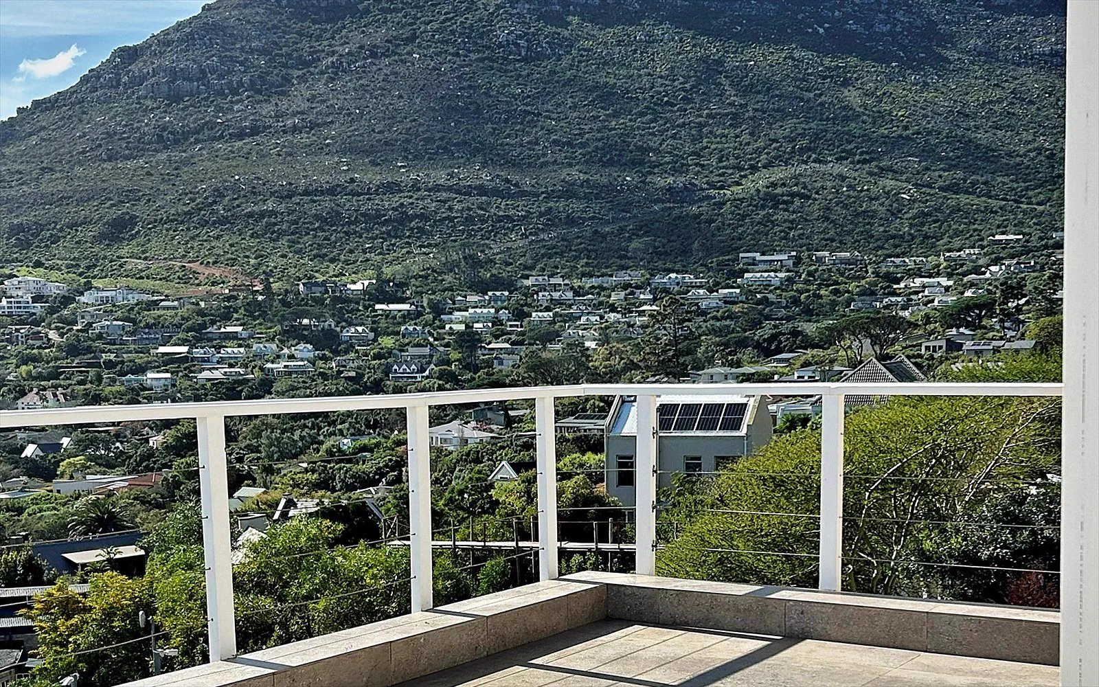 Spacious private sun terrace with balustrade and a view of the mountainside