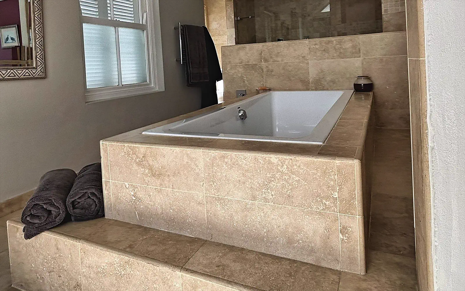 Travertine bath in the private bathroom of The Penthouse