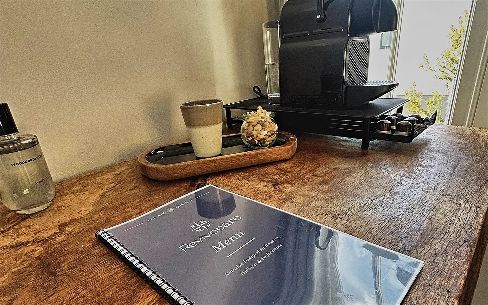 Espresso machine and menu on the wooden desk by the window