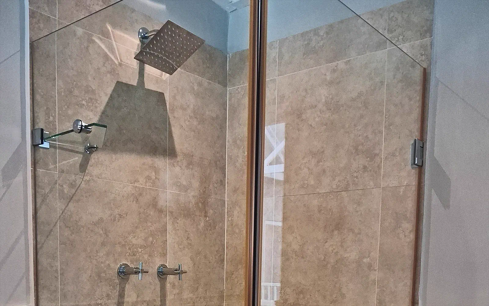 Walk-in rain shower behind glass in the bathroom of The Split